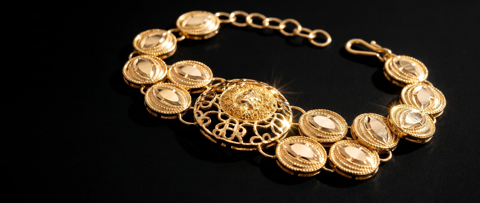 Low raking light across the disc links of a 22 carat gold bracelet, every engraved line thrown into relief