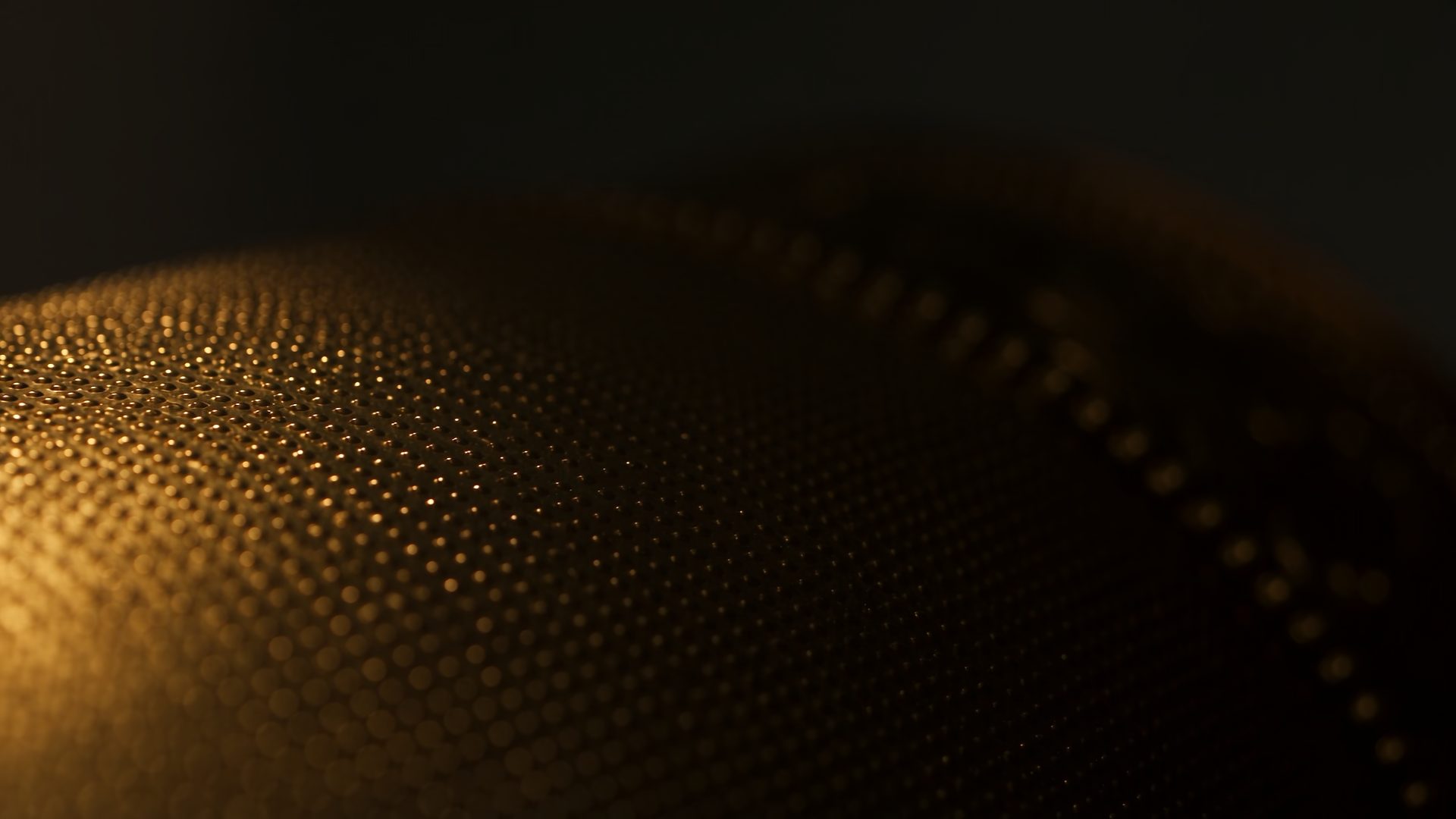Raking light travelling across the granulation and twisted wire of a worked gold surface